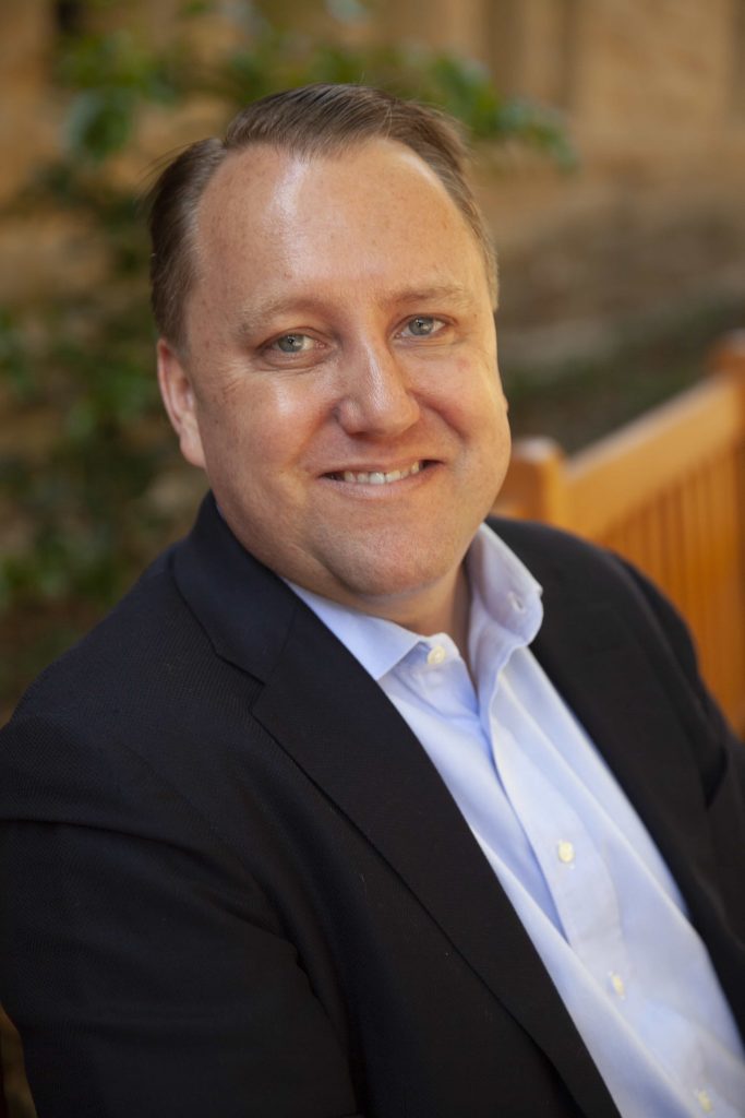  A portrait image of Louis Lehot wearing a suit and tie.