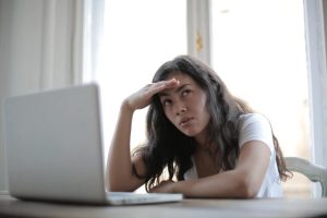 Photo of exhausted woman standing up to cyber violence