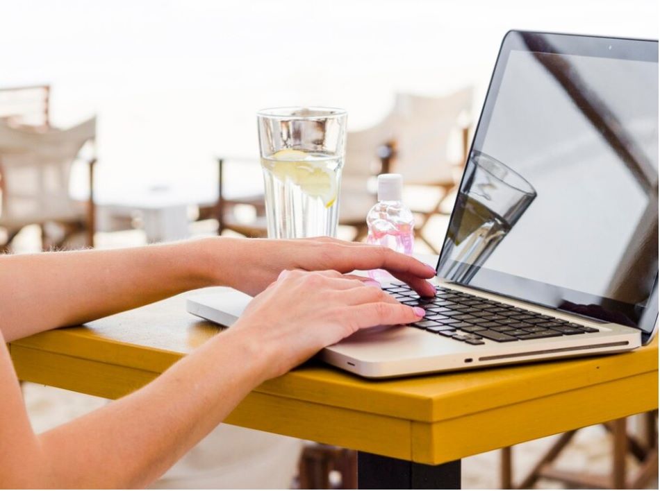 Side view of woman working on laptop outside