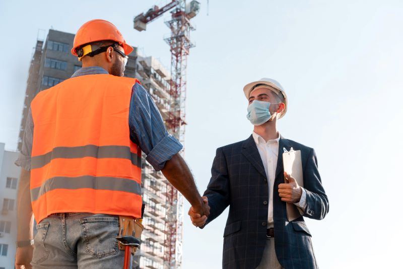 Building and construction worker on the site with architect