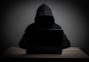 man-hides-himself-behind-a-computer-to-commit-blackmail.