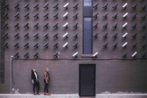 two-people-standing-under-cctv-cameras