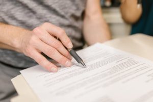 person writing on a white paper