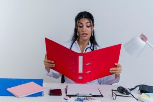 a dentist looking into a big file