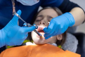 A dentist treating a young patient