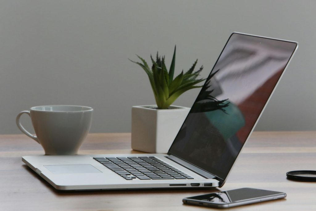 Silver-Laptop-and-White-Cup-on-Table