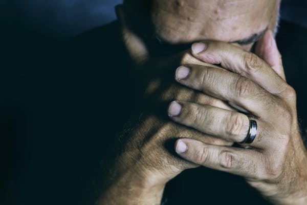 a-sad-man-covering-his-face-with-his-hands