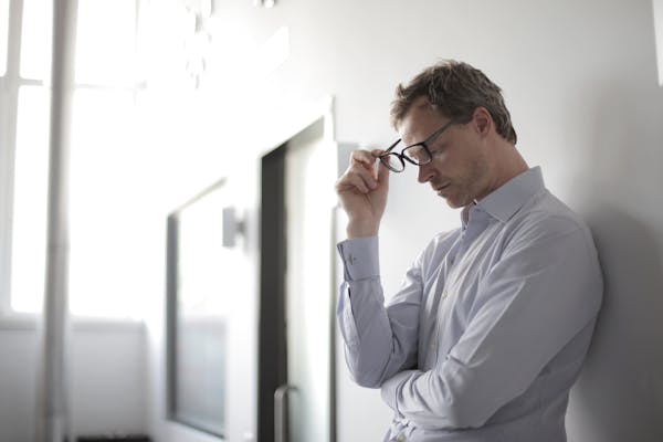 photo-of-man-holding-black-eyeglasses