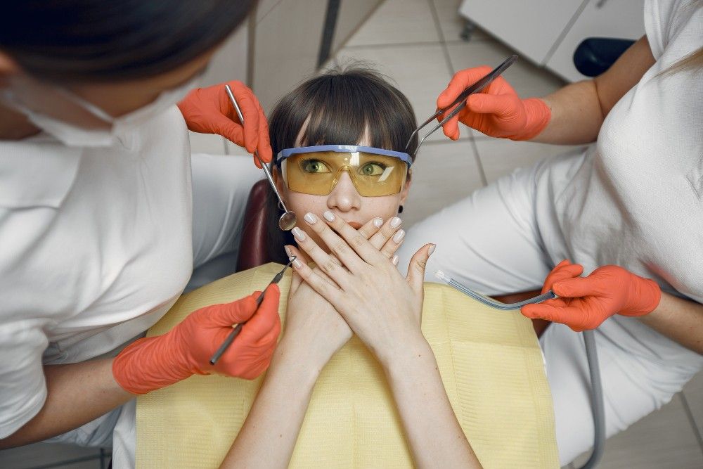 woman-dental-chair-girl-covers-her-mouth-dentists-treat-girl-s-teeth