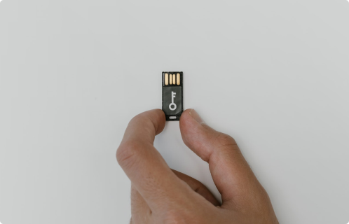 Systemic Strengthening Hand-holding-a-USB-security-key-symbolizing-systemic-strengthening