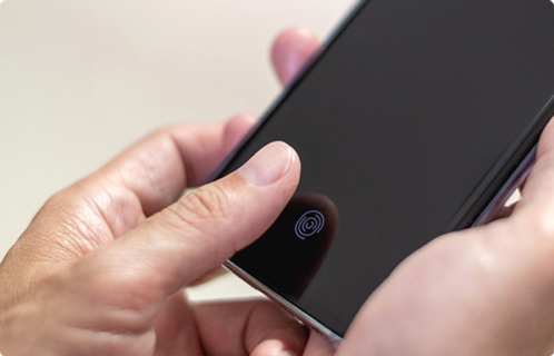 Online Privacy Hands-using-a-smartphone's-fingerprint-scanner-symbolizing-online-privacy-and-security