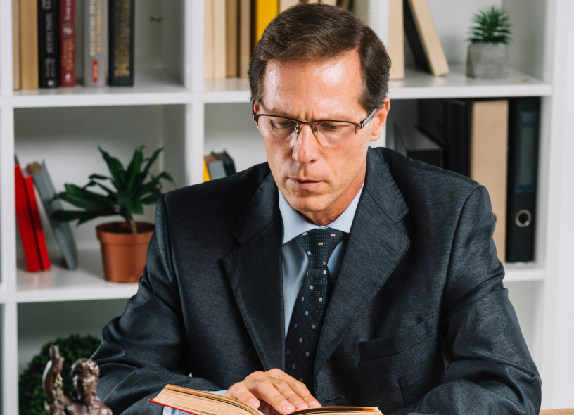 Image of person reading book a-person-reading-book-seriously