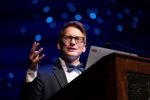 Jacob K. Friefeld speaking at a professional seminar 